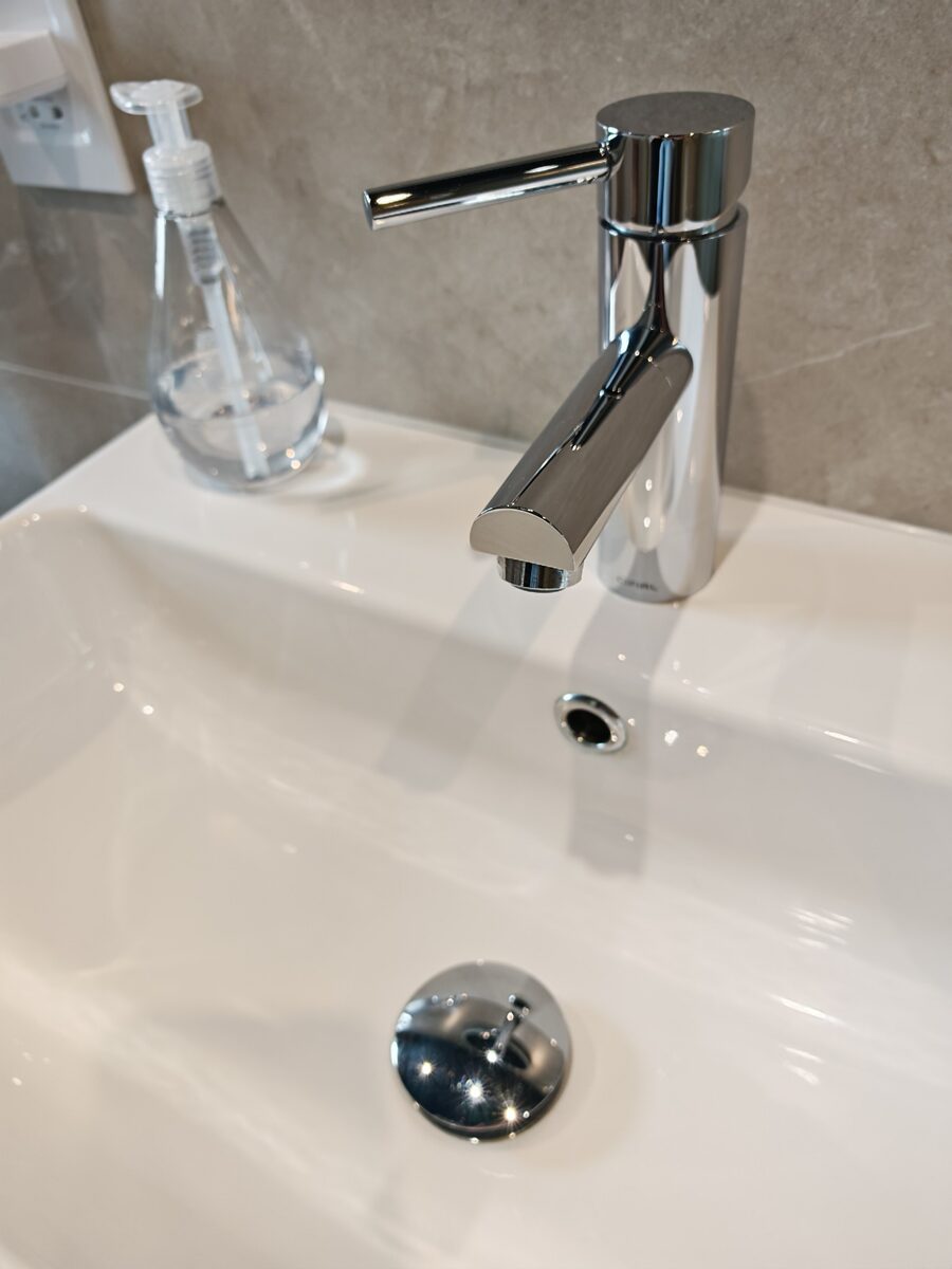 Polished bathroom basin and chrome tap