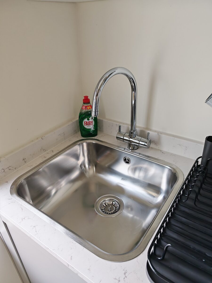 Clean kitchen sink and worktop in a holiday let