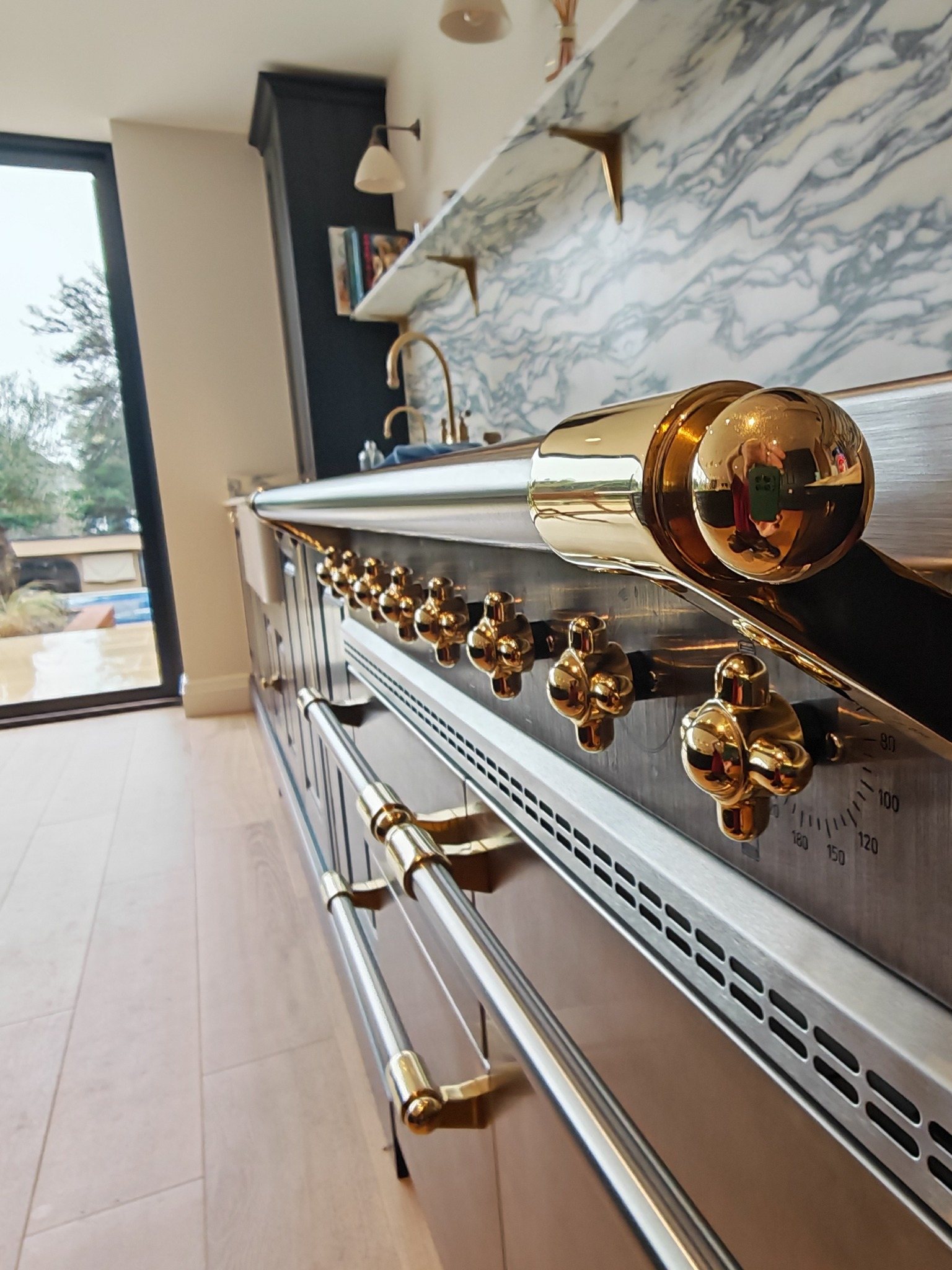 Polished brass oven controls
